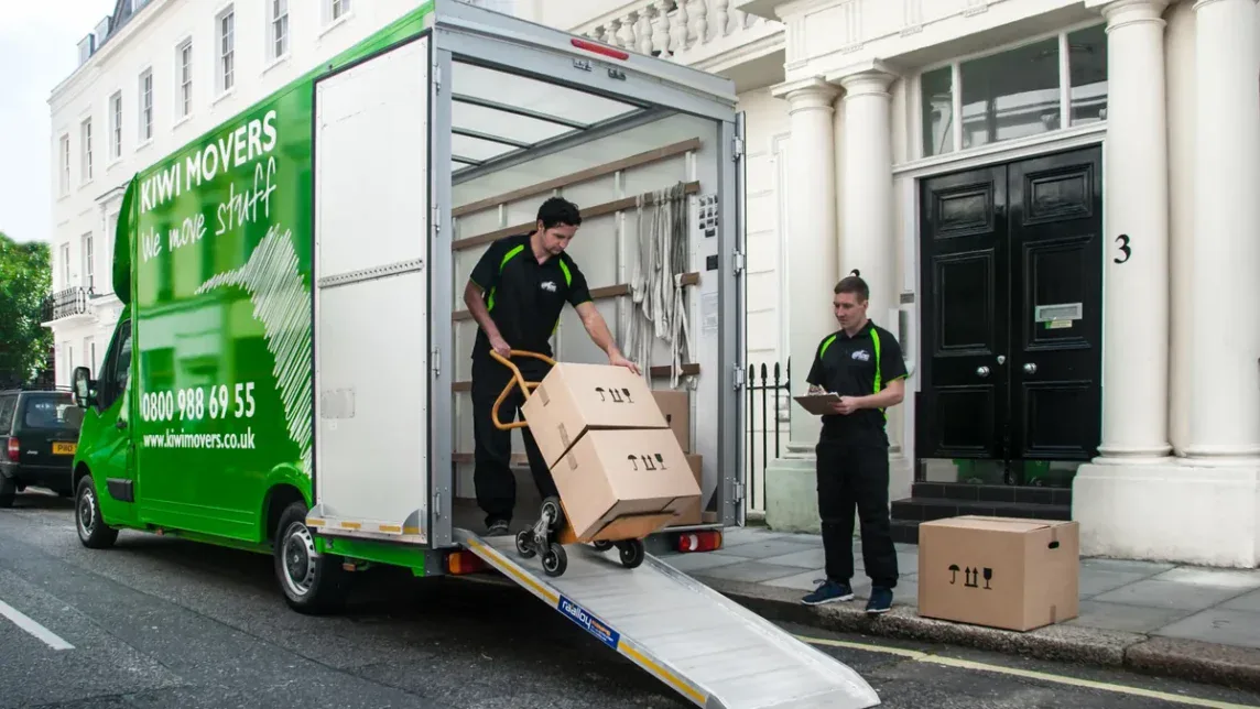 Kiwi Movers commercial man and van service loading boxes outside a London property