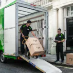 Kiwi Movers commercial man and van service loading boxes outside a London property