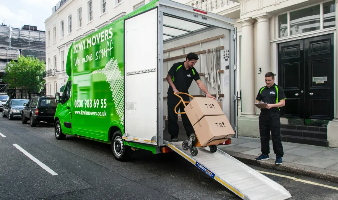 Kiwi Movers delivery team unloading boxes from van in London residential street